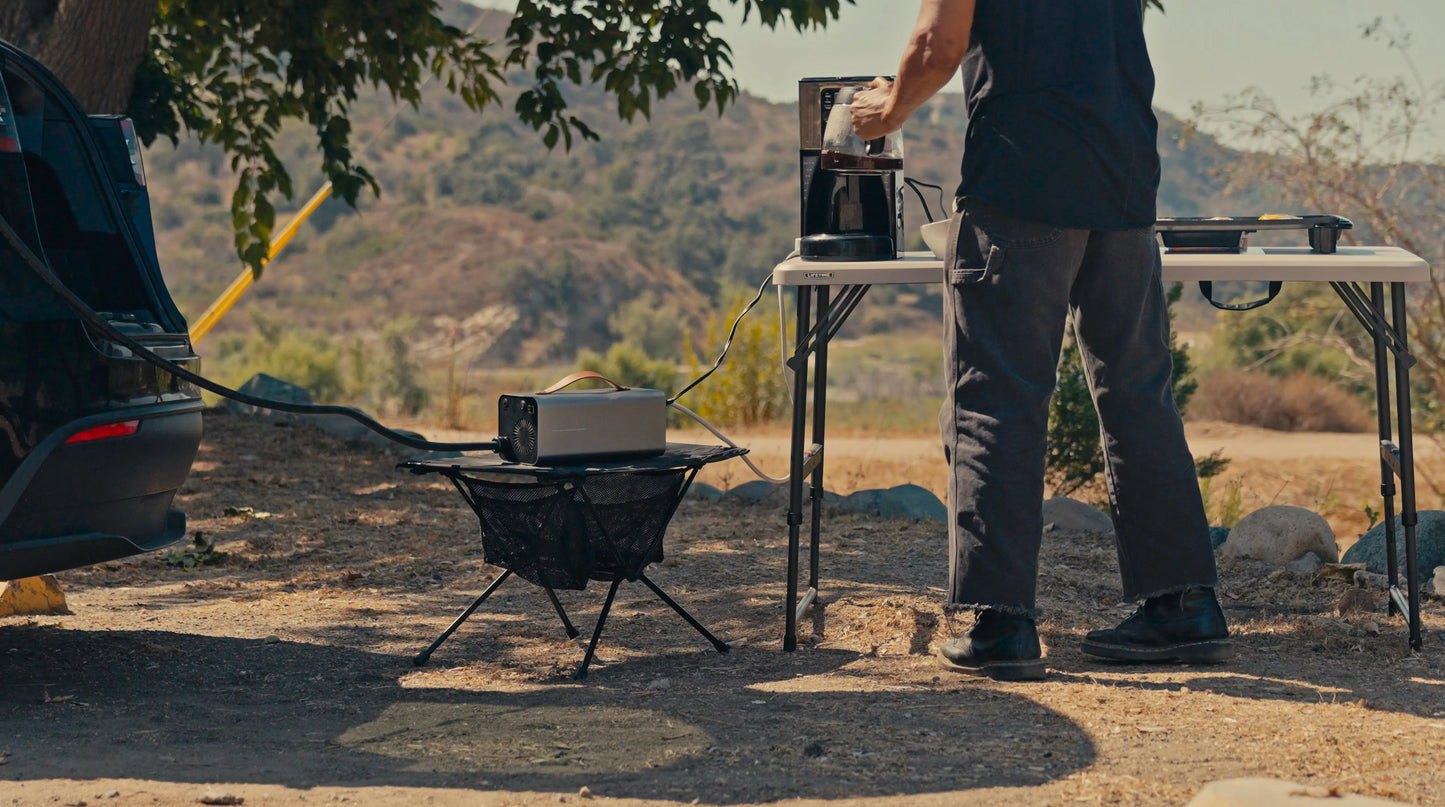 Camping setup: running lights and outdoor gear from Tesla 120V power.