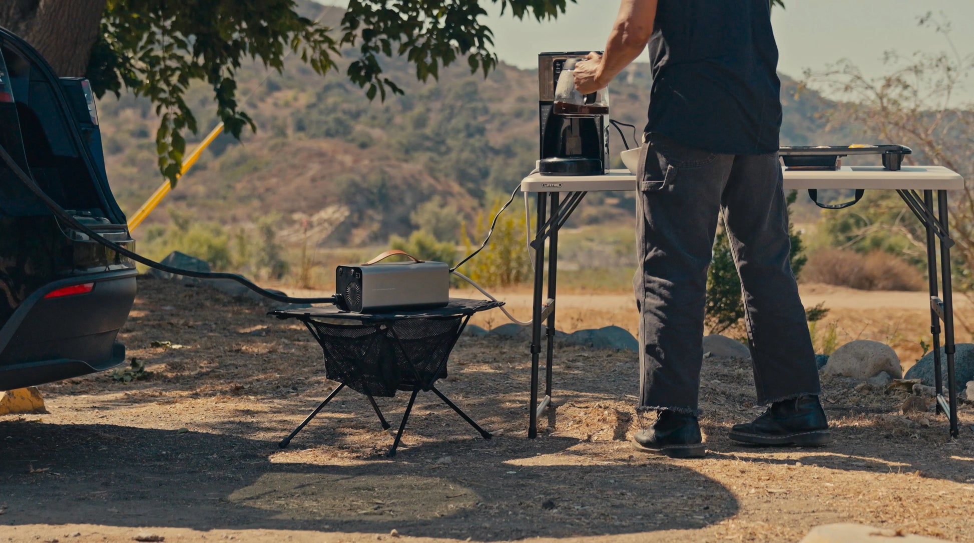 Camping setup: running lights and outdoor gear from Tesla 120V power.