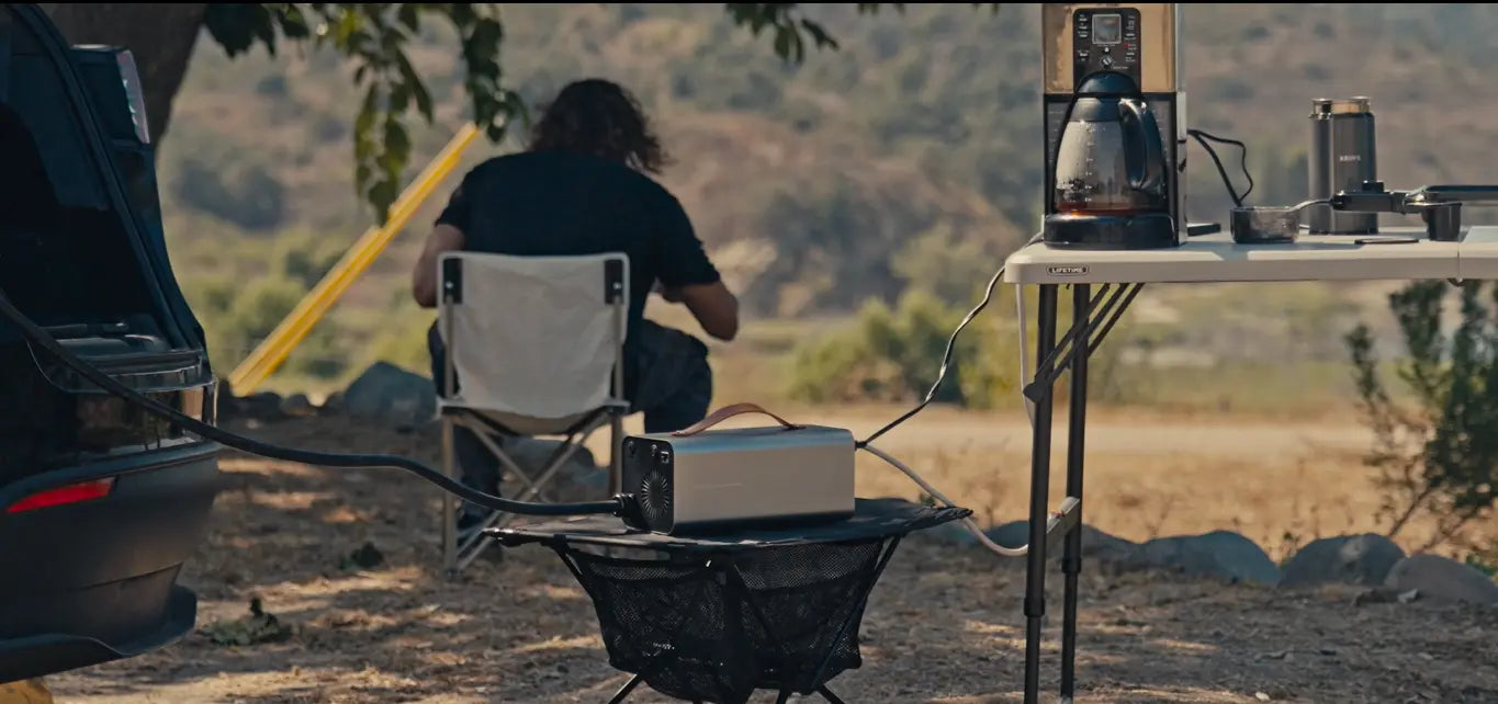 Tesla with RoamEnergy Discharger at campsite running lights and cooking equipment