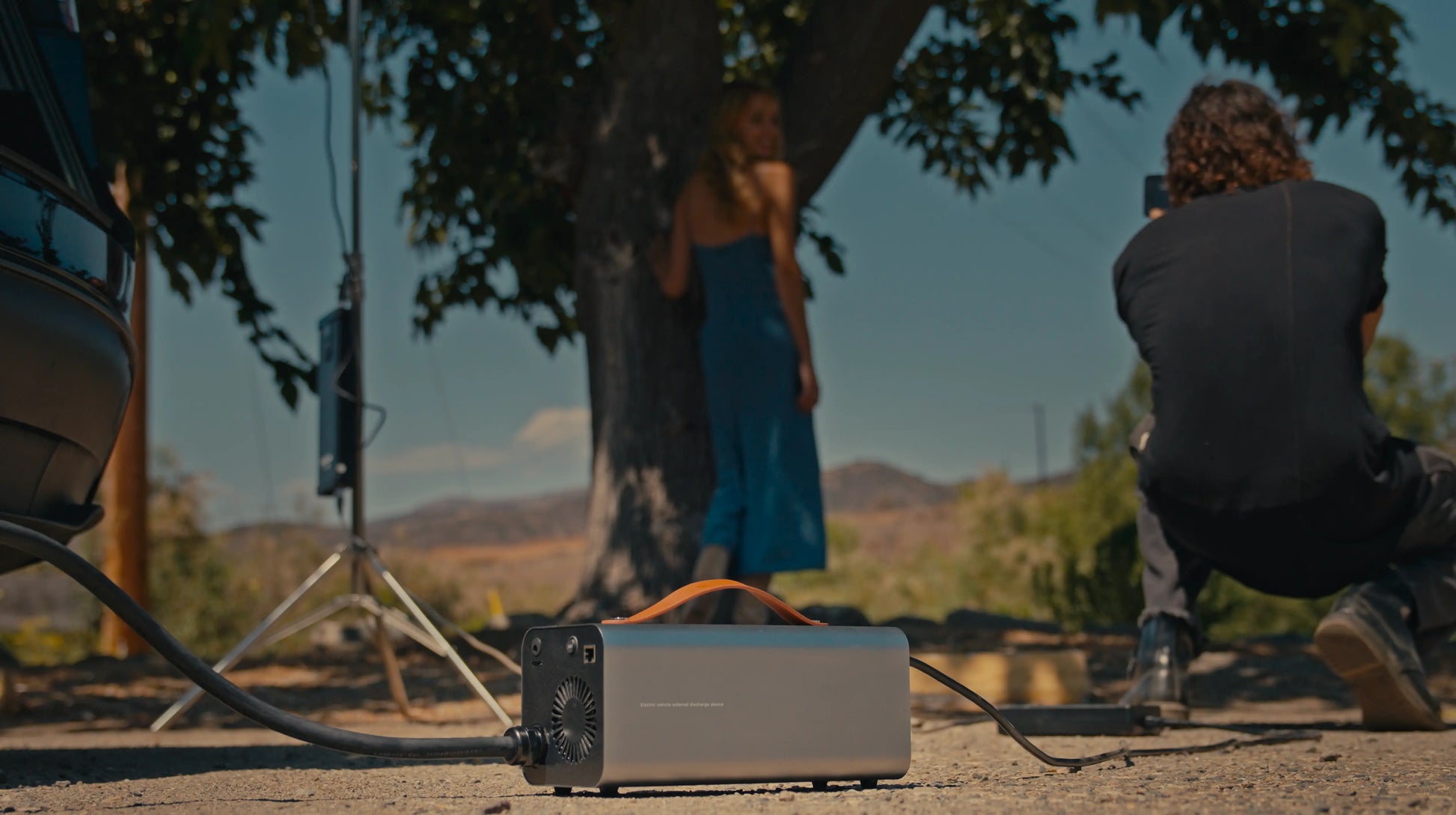 RoamEnergy EV Discharger supporting cameras, drones, and projector for photography work