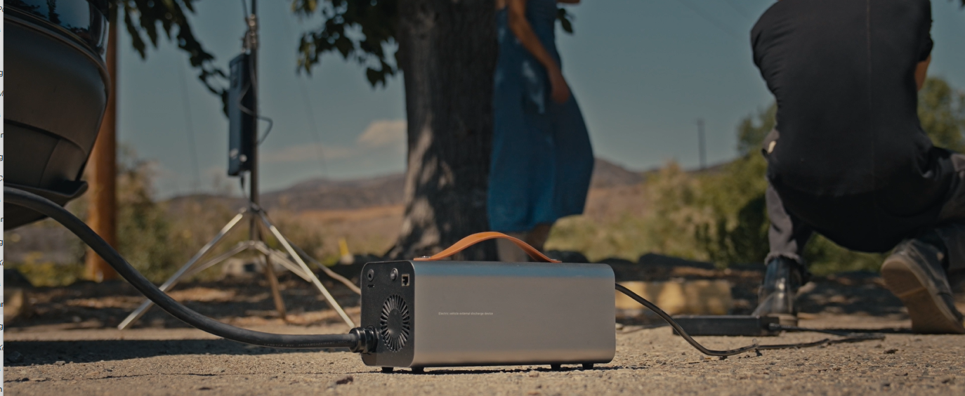RoamEnergy powering film lights and camera gear—portable 120V from Tesla